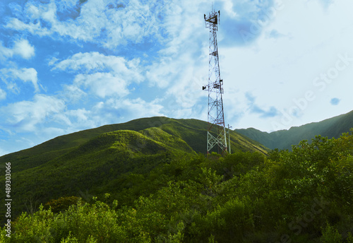 High telecommunication tower located on hill