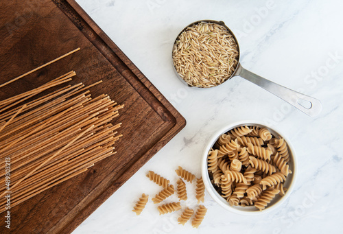 Healthy grains of brown rice, and whole wheat pasta photo