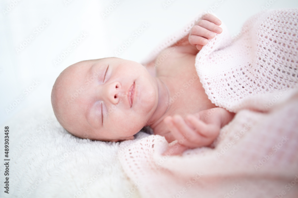 Peaceful sleep. A beautiful infant girl sleeping while wrapped up in a blanket. Peaceful sleep. A beautiful infant girl sleeping while wrapped up in a blanket.
