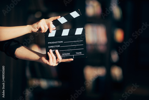 Hands Holding a Film Slate Directing a Movie Scene photo