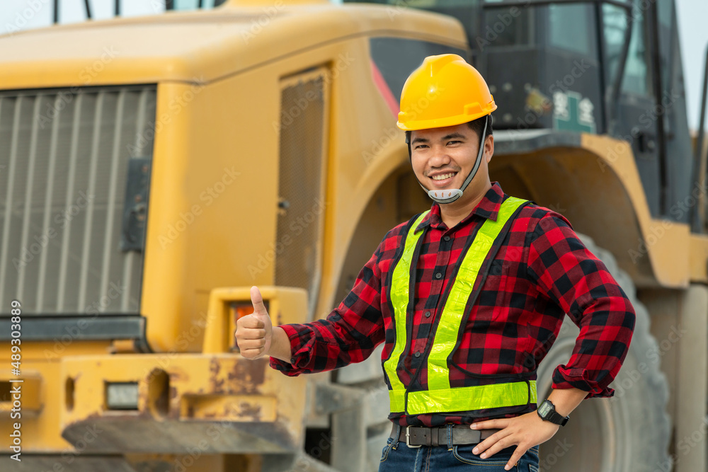 asian driver wear safety uniform backhoe excavator and bulldozer on construction site asian driver wear safety uniform backhoe excavator and bulldozer on construction site