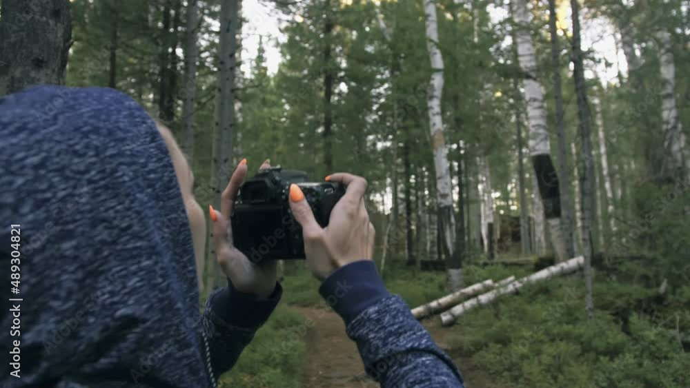 Traveler photographing scenic view in forest. One caucasian woman shooting nice magic look. Girl take photo video on dslr mirrorless camera. Professional photographer travel with backpack. Outdoor. Traveler photographing scenic view in forest. One caucasian woman shooting nice magic look. Girl take photo video on dslr mirrorless camera. Professional photographer travel with backpack. Outdoor.