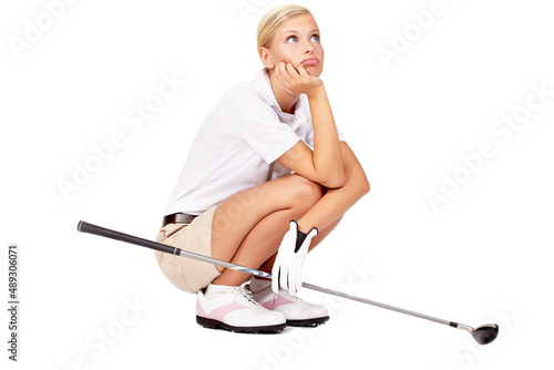 Will the others never finish this hole. Full length studio shot of a bored-looking female golfer crouching with her golf club isolated on white.