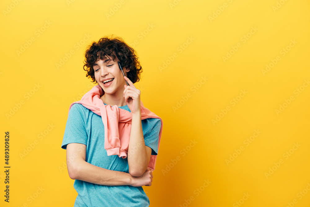curly guy thinks with a pen in his hands isolated backgrounds curly guy thinks with a pen in his hands isolated backgrounds