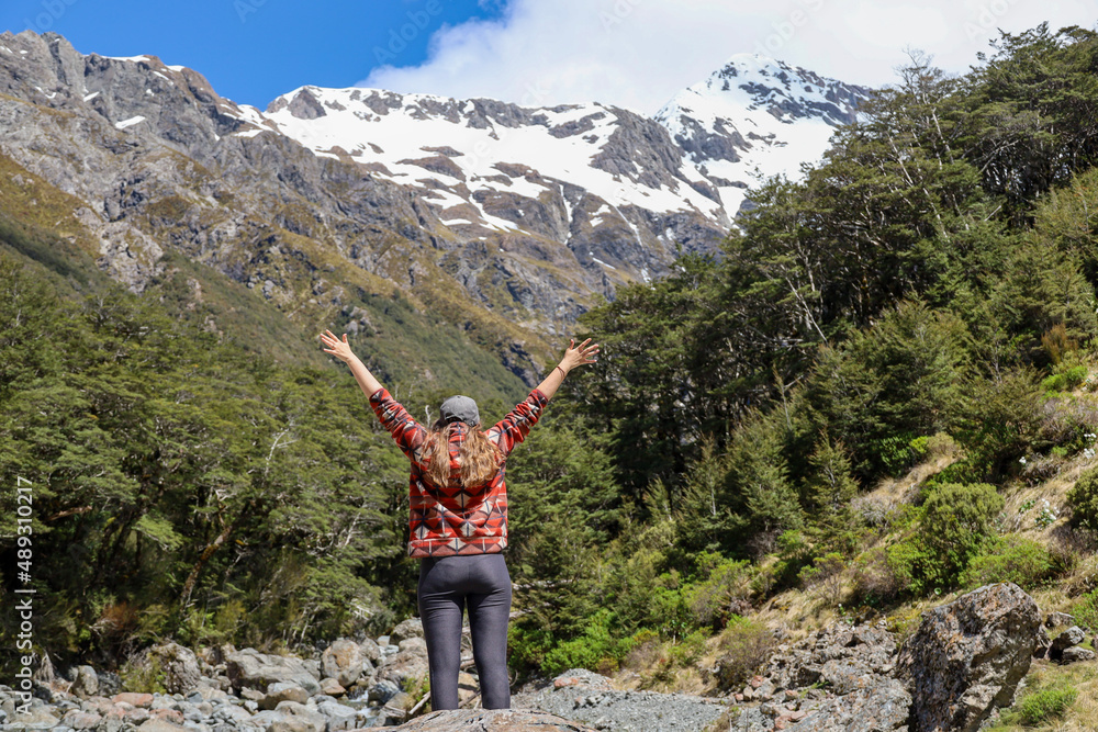 woman lifting arms in the mountains