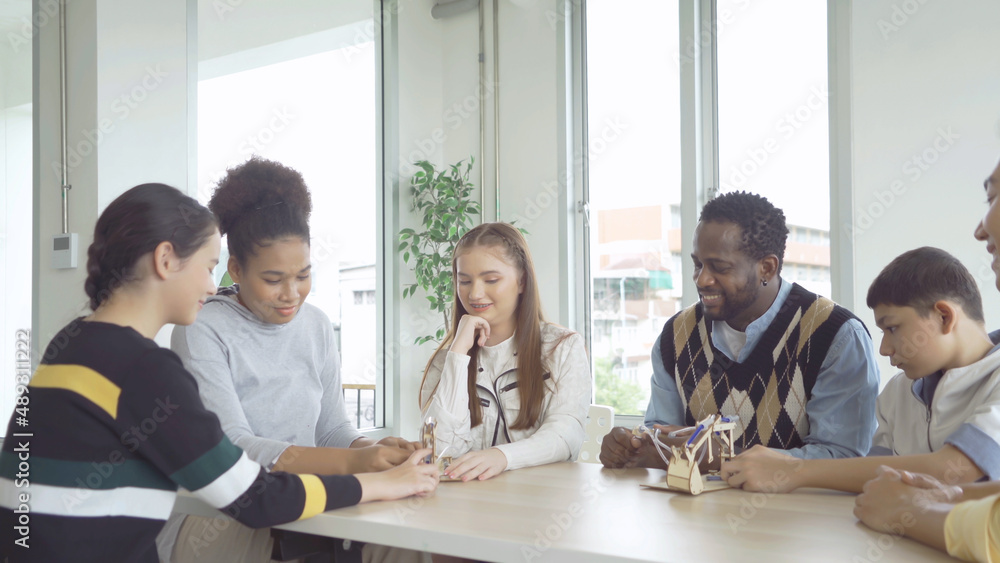 A group of multi ethnic of students kids and teachers study, learn a puzzle toy in school. Education in classroom. People lifestyle A group of multi ethnic of students kids and teachers study, learn a puzzle toy in school. Education in classroom. People lifestyle