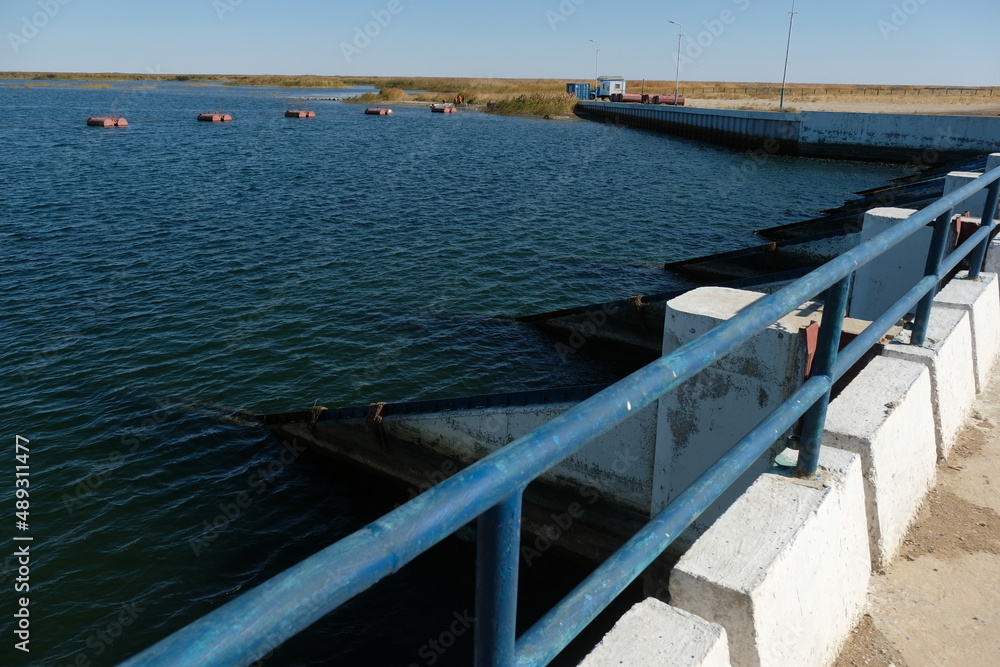 Aralsk, Kazakhstan - 10.06.2020 : The territory of the Kokaral dam. Regulation of the water level in the small Aral Sea. Aralsk, Kazakhstan - 10.06.2020 : The territory of the Kokaral dam. Regulation of the water level in the small Aral Sea.