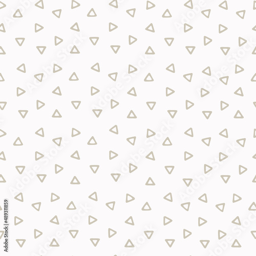 Seamless geometric pattern with hand drawn uneven beige small triangles on white background for surface design, craft, apparel and other design projects