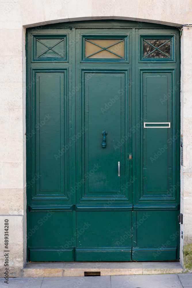 green door home entrance wooden double doors painted in Paris