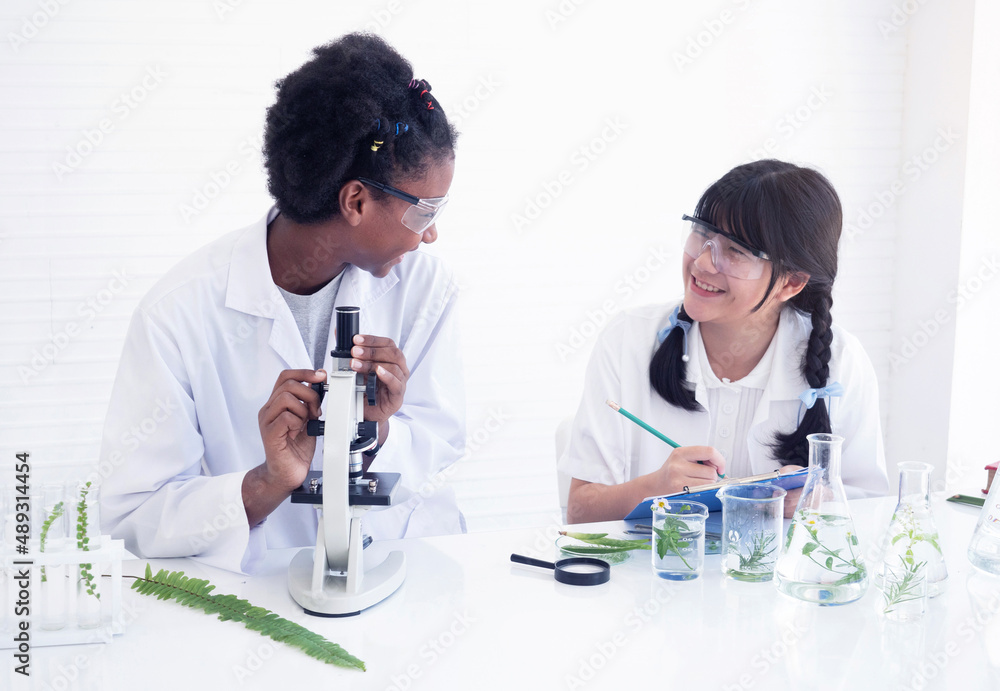 Group of teenage student studying science, experimenting with chemicals. Education and science concept. Group of teenage student studying science, experimenting with chemicals. Education and science concept.