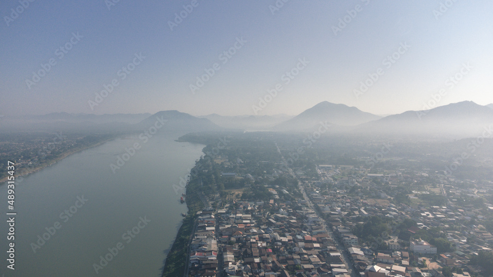 Aerial view of Chiang Khan Old Village during misty morning by drone. Village along the Mekong River are Thai-Laos border, which is now a famous tourist attraction of Loei Province Thailand.