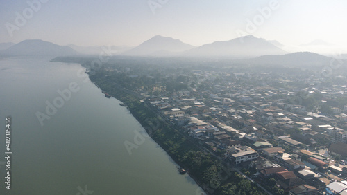 Aerial view of Chiang Khan Old Village during misty morning by drone. Village along the Mekong River are Thai-Laos border, which is now a famous tourist attraction of Loei Province Thailand.