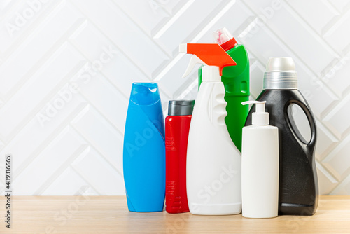 Cleaning concept. Set of cleaning detergents in colored plastic bottles. Clean house.