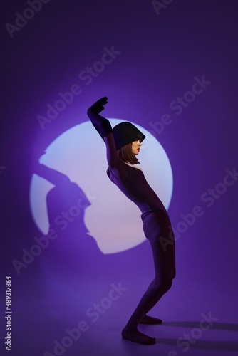 glamorous woman posing on stage spotlight silhouette disco color background unaltered © SHOTPRIME STUDIO