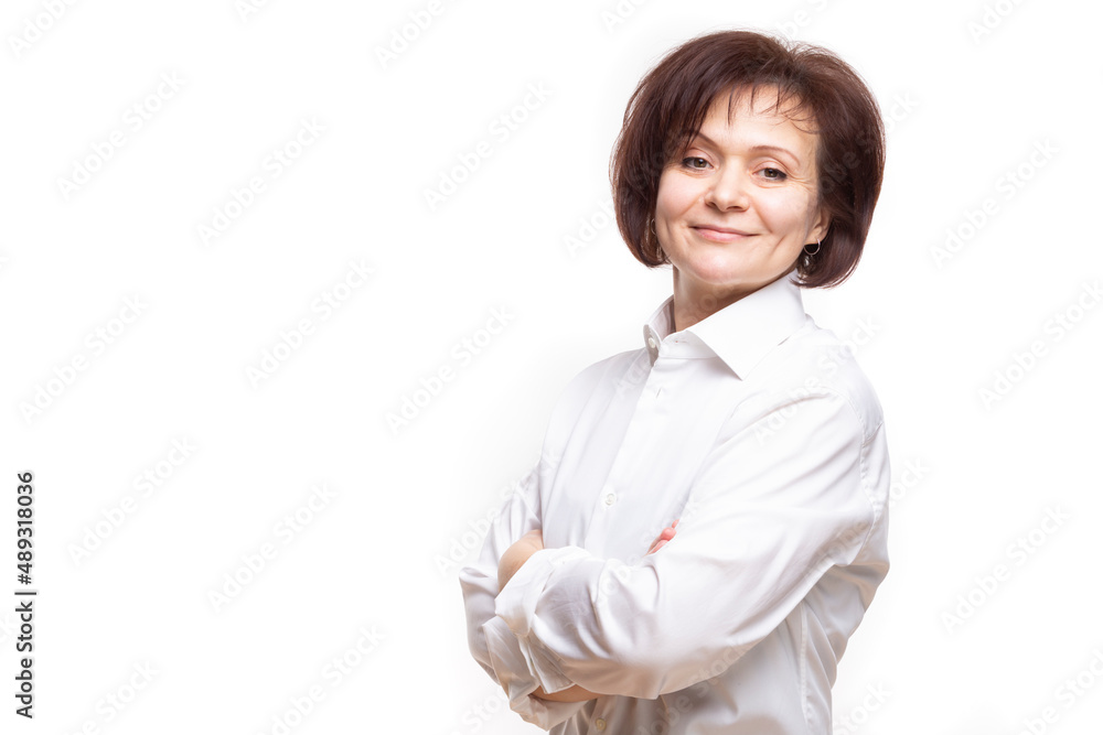 Natural Portrait of Smiling Mature Confidant Brunette Caucasian Business Woman in Whitre Shirt Posing With Hands Folded On White. Natural Portrait of Smiling Mature Confidant Brunette Caucasian Business Woman in Whitre Shirt Posing With Hands Folded On White.