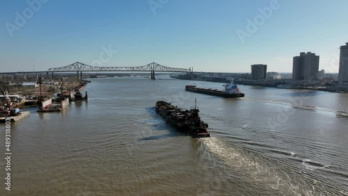 Barge and Pushboat near the Mississippi River bridge in New Orleans photo