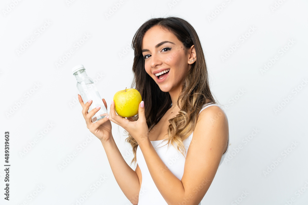 Young caucasian woman isolated on white background with an apple and with a bottle of water Young caucasian woman isolated on white background with an apple and with a bottle of water