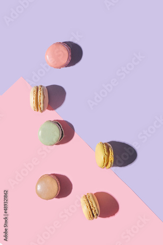 Artisan patisserie minimal concept. Yummy macarons awesome flat lay arrangement with pastel pink and very peri background