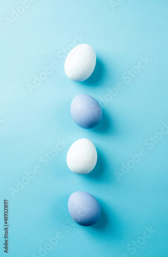 Pastel colored easter eggs on blue background