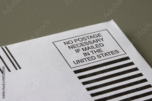 Canvas-taulu Closeup of a No Postage Necessary if Mailed in the United States envelope isolated on a gray background