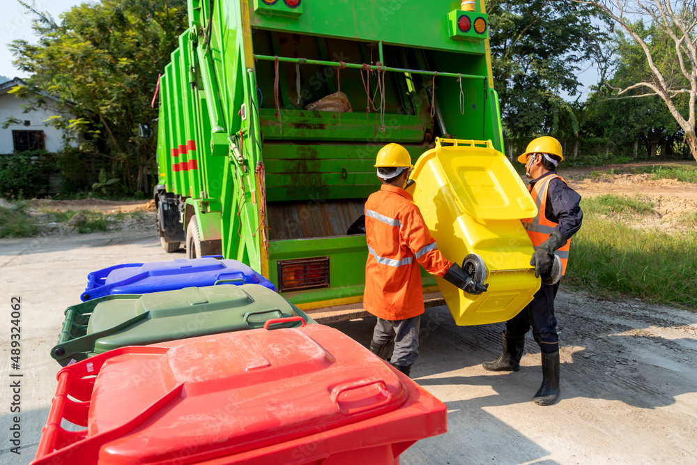Two Workers collecting garbage of urban municipal are collecting for