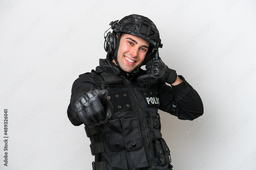 SWAT caucasian man isolated on white background making phone gesture and pointing front SWAT caucasian man isolated on white background making phone gesture and pointing front