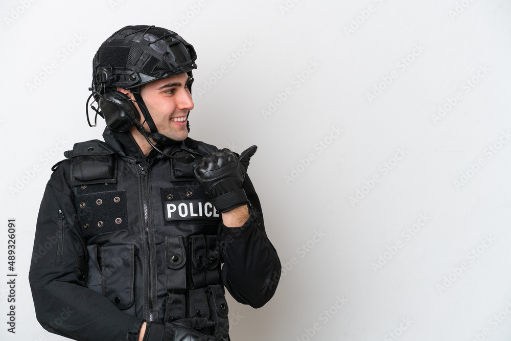 SWAT caucasian man isolated on white background pointing to the side to present a product SWAT caucasian man isolated on white background pointing to the side to present a product