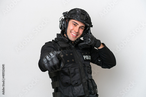 SWAT caucasian man isolated on white background making phone gesture and pointing front