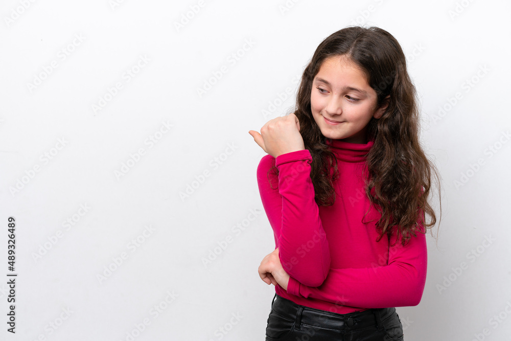Little girl isolated on white background pointing to the side to present a product Little girl isolated on white background pointing to the side to present a product