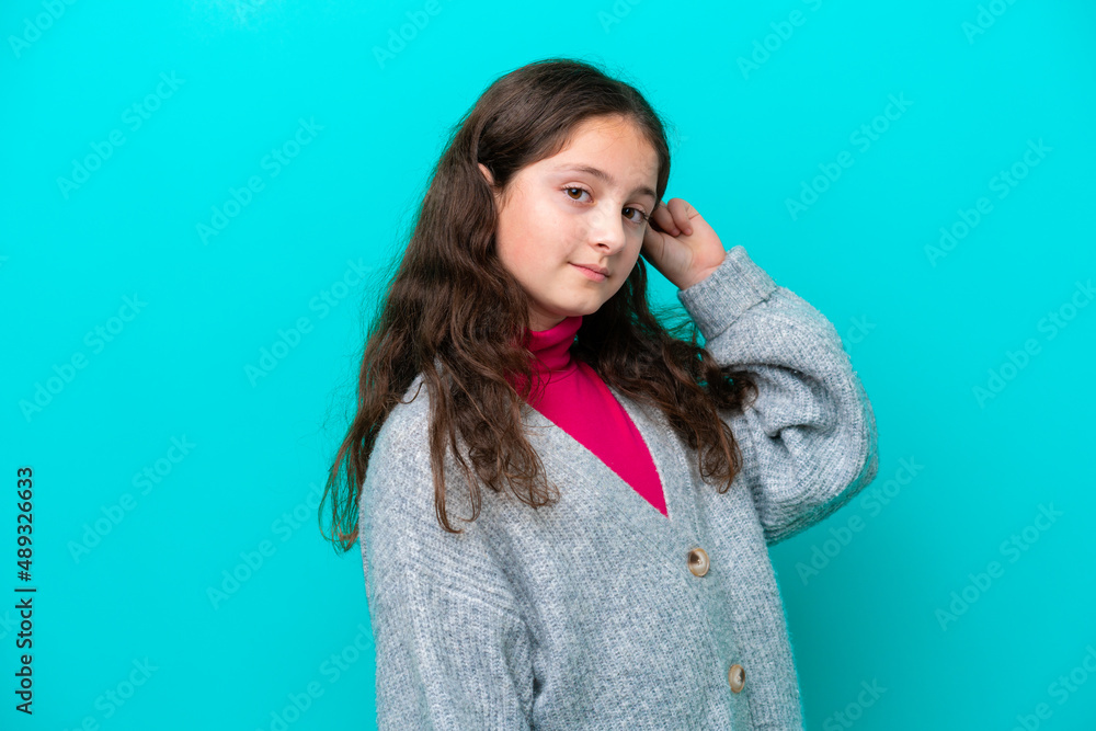 Little girl isolated on blue background having doubts Little girl isolated on blue background having doubts