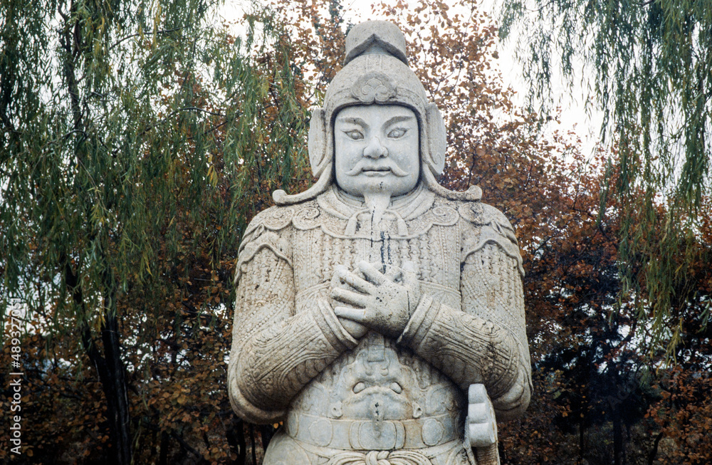 Ornate stone-carved Chinese warrior statues in a park near the Ming Tombs, northwest of Beijing, China. Warrior