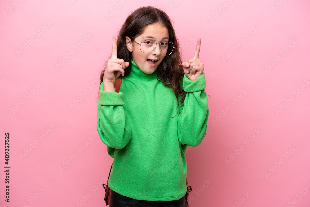 Little student girl isolated on pink background pointing up a great idea Little student girl isolated on pink background pointing up a great idea