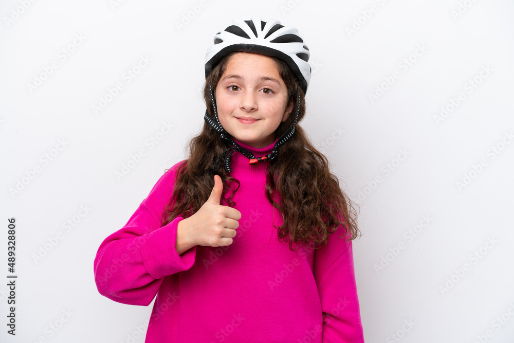 Little cyclist girl isolated on white background with thumbs up because something good has happened Little cyclist girl isolated on white background with thumbs up because something good has happened