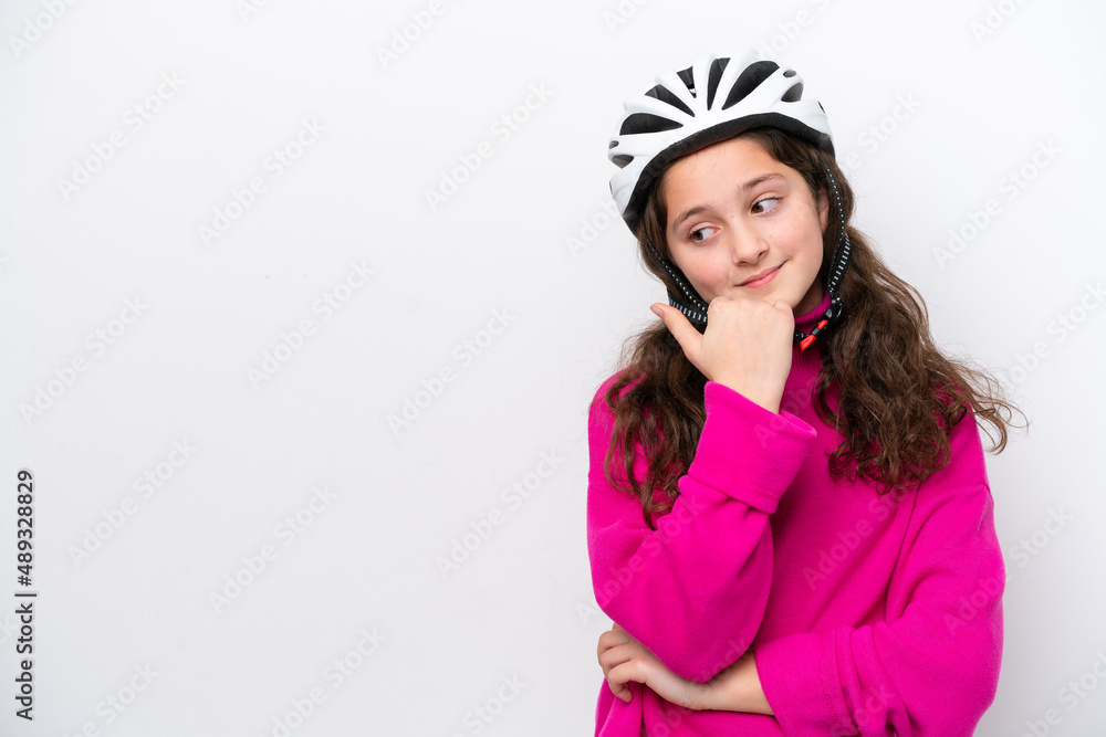 Little cyclist girl isolated on white background pointing to the side to present a product Little cyclist girl isolated on white background pointing to the side to present a product