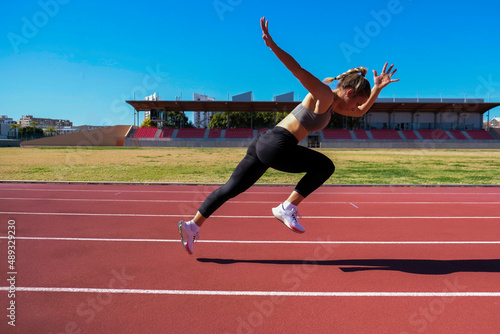 girl running on athletics tracks