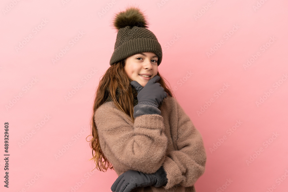 Little girl with winter hat isolated on pink background happy and smiling Little girl with winter hat isolated on pink background happy and smiling