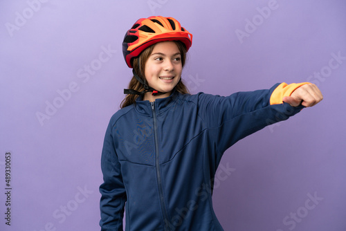 Little caucasian girl isolated on purple background giving a thumbs up gesture © luismolinero