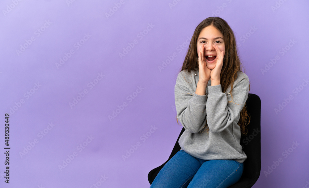 Little caucasian girl sitting on a chair isolated on purple background shouting and announcing something Little caucasian girl sitting on a chair isolated on purple background shouting and announcing something