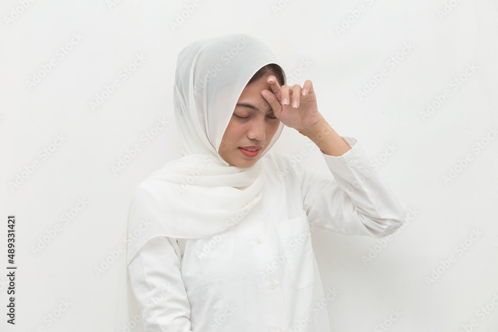 stressed sick muslim woman with headache; ill woman suffers from vertigo dizziness migraine hangover stressed sick muslim woman with headache; ill woman suffers from vertigo dizziness migraine hangover