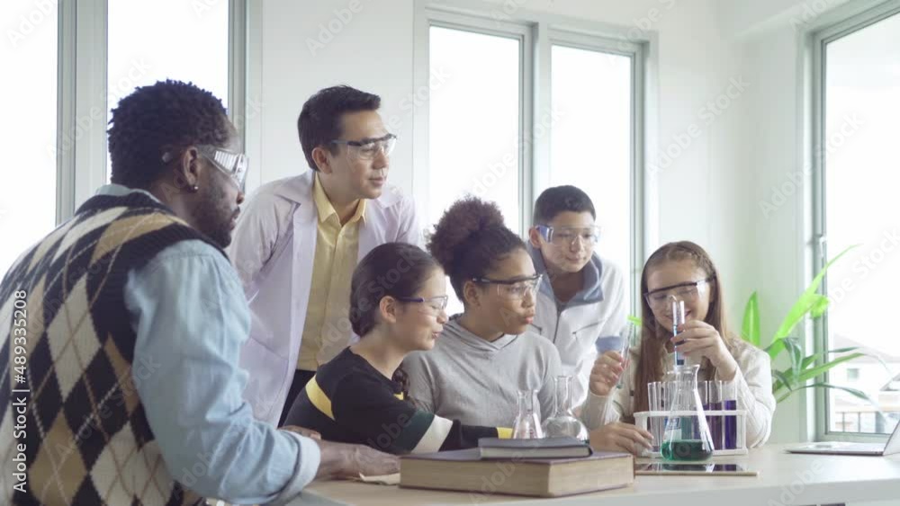 A group of multi ethnic of students kids and teachers study, learn on test tube in lab or laboratory in school, medical, chemistry. Experiment science. Education in classroom. People lifestyle A group of multi ethnic of students kids and teachers study, learn on test tube in lab or laboratory in school, medical, chemistry. Experiment science. Education in classroom. People lifestyle