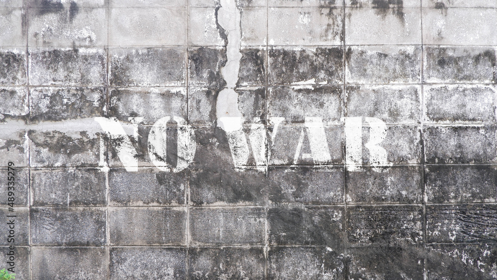 Concrete wall with text no war
