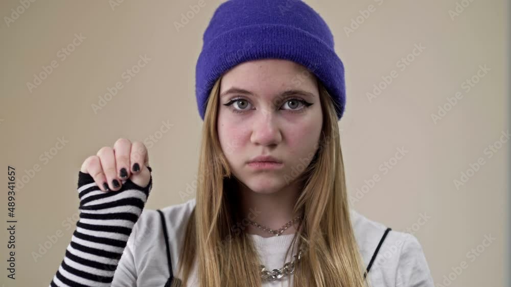 Frightened teenage girl asks for help. A gesture denoting a person's need for help. Frightened teenage girl asks for help. A gesture denoting a person's need for help.