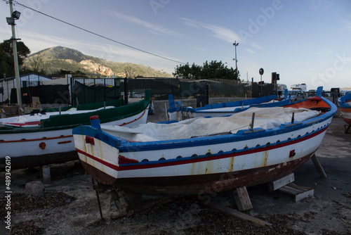 evocative image of fishing boats moored in the harbor in a small fishing village in Sicily, Italy 