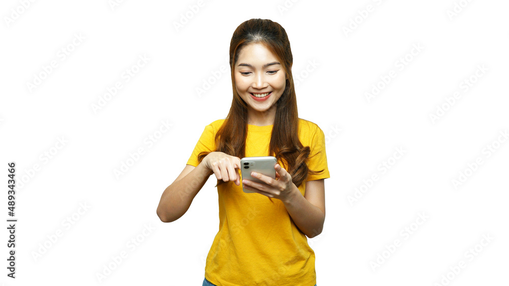 Young Asian woman touching and looking to smartphone screen and smiling, enjoying using application on smartphone for communication, online shopping or social media, white background. Young Asian woman touching and looking to smartphone screen and smiling, enjoying using application on smartphone for communication, online shopping or social media, white background.