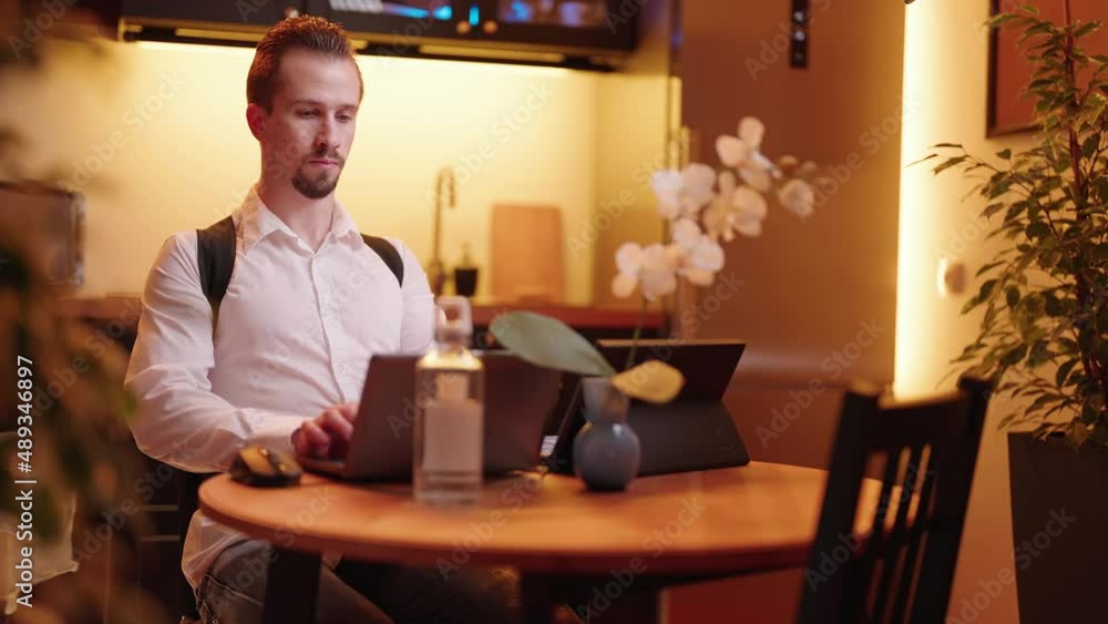 Man behind laptop computer wearing posture correction belt preventing pain work at home 4K Man behind laptop computer wearing posture correction belt preventing pain work at home 4K