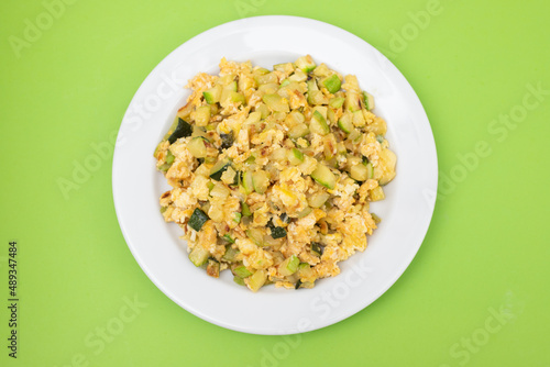 scrambled egg with zucchini on white small plate