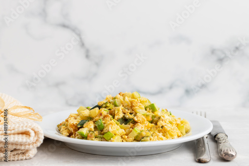 scrambled egg with zucchini on white small plate photo