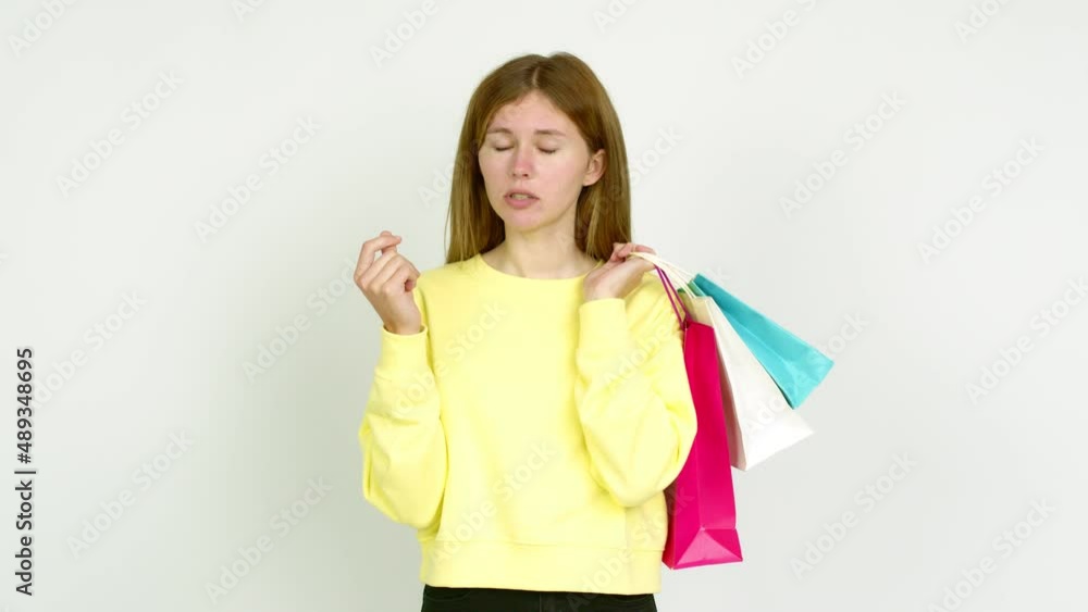 Young woman holding shopping bags and doing ruined gestured isolated on background Young woman holding shopping bags and doing ruined gestured isolated on background
