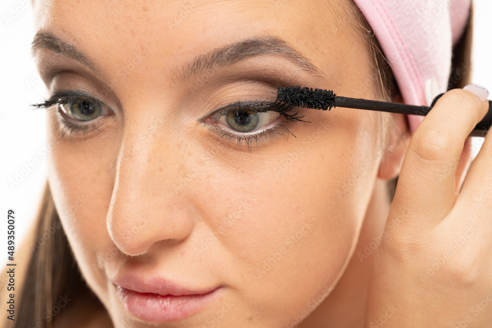 Closeup of woman applying mascara