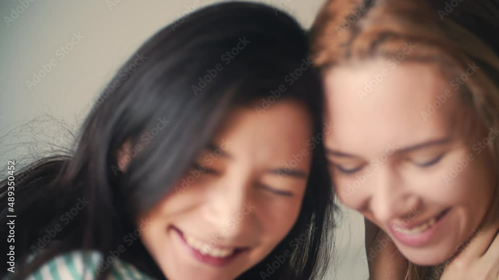 Homosexual lesbian couple lying in bed together. Take hands and smile each other with love. Family, woman love and romantic relationship. Beautiful asian girlfriend in morning home. LGBT pride event. Homosexual lesbian couple lying in bed together. Take hands and smile each other with love. Family, woman love and romantic relationship. Beautiful asian girlfriend in morning home. LGBT pride event.